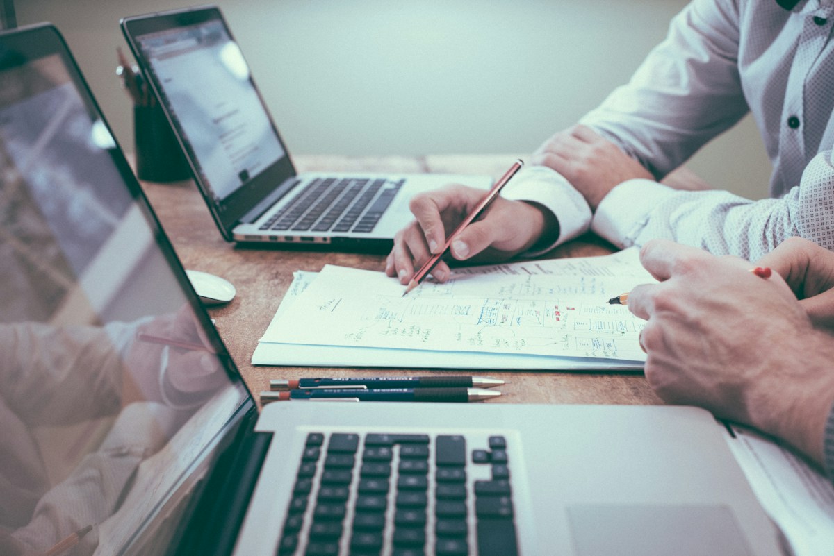 Two people reviewing business records together at a desk